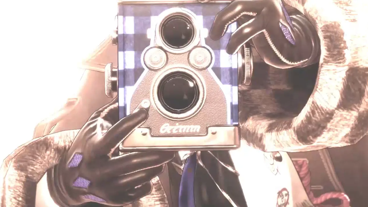 Close-up of the boxy twin-lens camera with its script brand logo, held up to the light